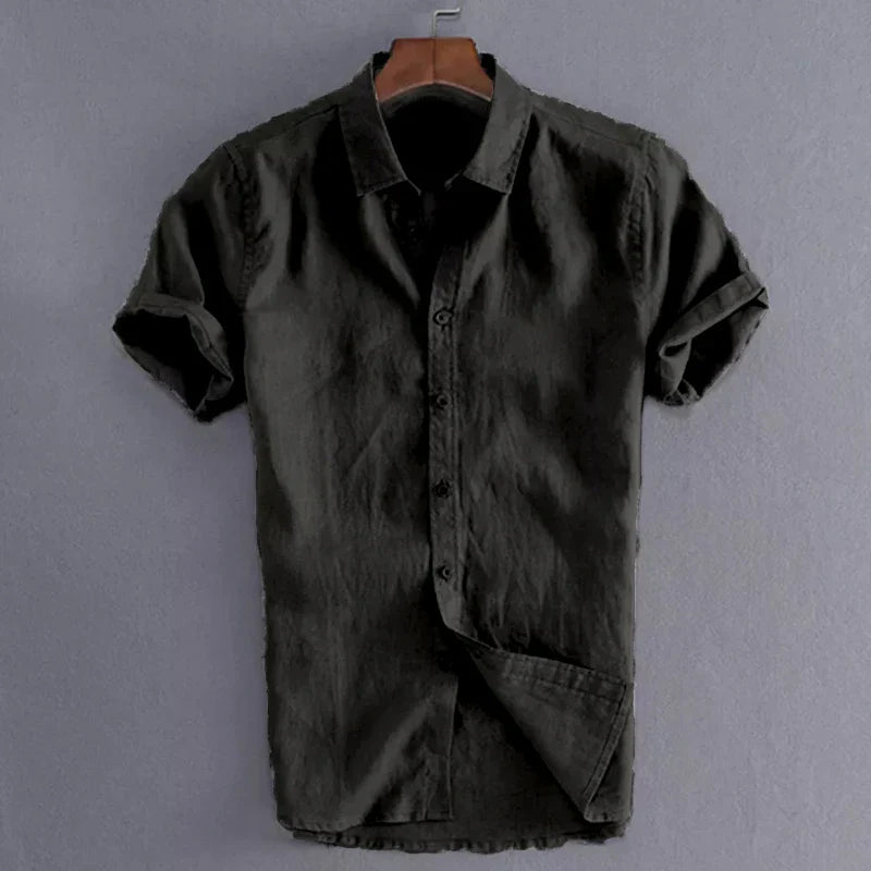 Men's casual short sleeve black shirt hanging on wooden hanger against gray background