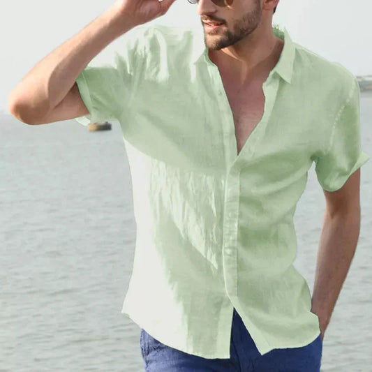 Men's casual short sleeve shirt in light green worn outdoors by water