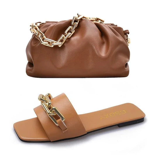 Brown women's flat shoe and matching handbag set with gold chain detail, made of high-quality PU leather.