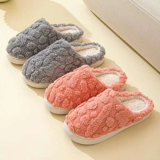 Pair of women's warm slippers in gray and coral colors with plush texture and slip-resistant soles for autumn and winter.