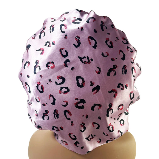 Women's large satin bonnet with pink leopard print and adjustable tie band for hair protection during sleep