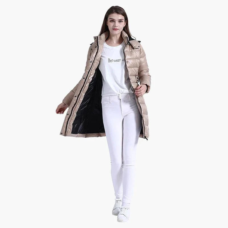woman wearing beige winter windproof warm jacket with hood and black inner lining, styled with white pants and white sneakers