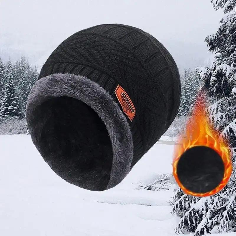 Black insulated winter hat for men with warm lining and knitted nylon exterior in snowy outdoor setting