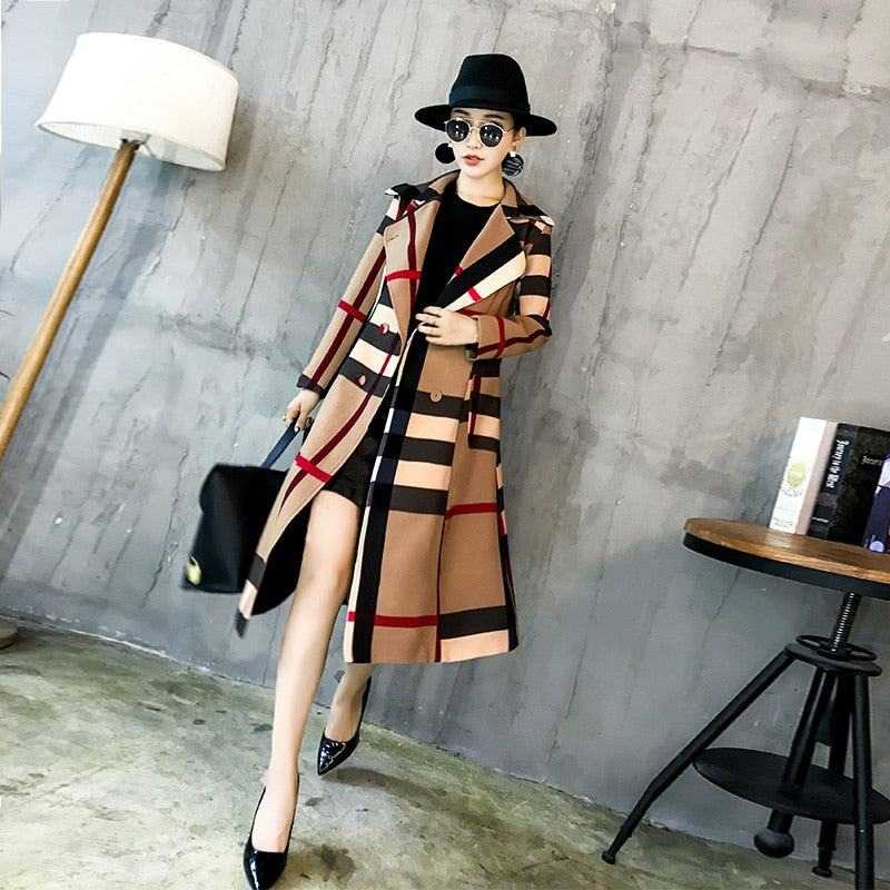 Woman wearing a stylish women's winter coat with a plaid pattern, paired with black accessories in a modern indoor setting