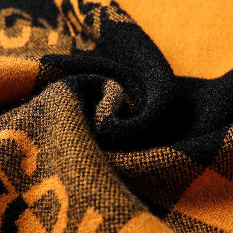 Close-up of soft warm fabric texture of men's autumn winter pullover in black and mustard colors
