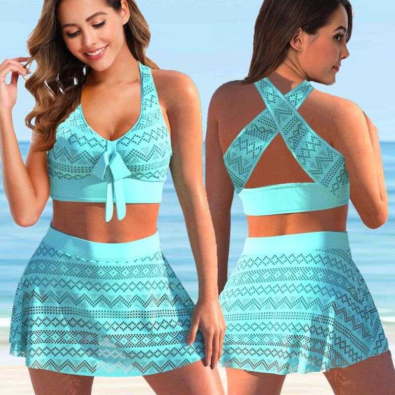 Two piece set women's swimwear with skirt in turquoise patterned fabric, front tie top and crisscross back straps, modeled on beach.