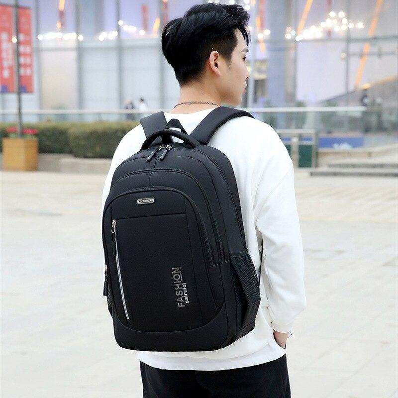 Teenager wearing black waterproof children school bag backpack outdoors