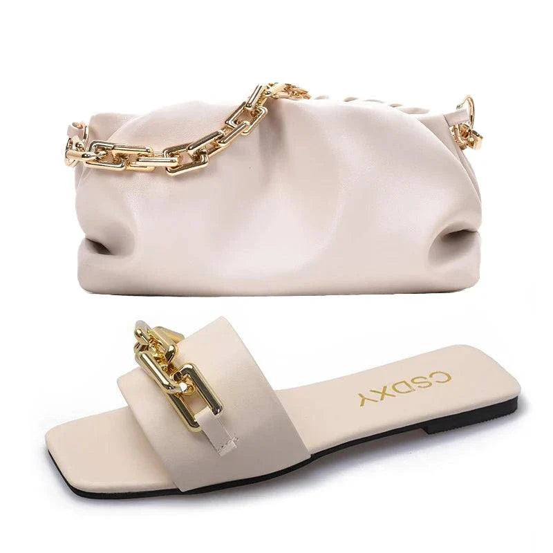 Beige women's flat shoes with gold chain detail and matching beige handbag with gold chain strap set