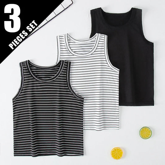 Children's 3 pieces set summer tank tops in black, white, and striped designs laid flat with lemon slice props