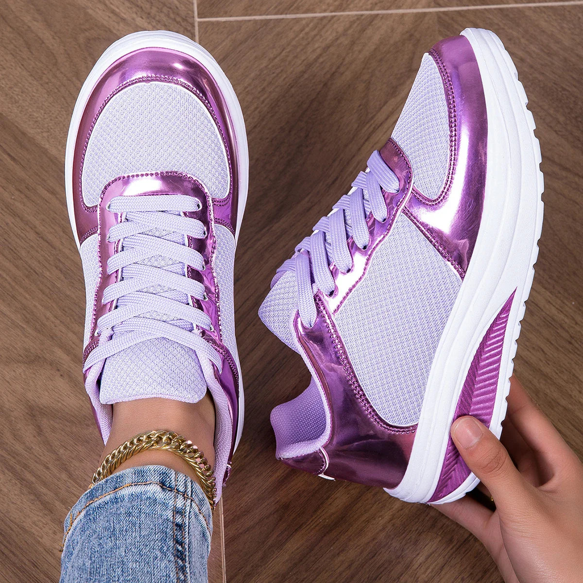 women's walking shoes in white and purple with metallic accents worn on feet on wooden floor