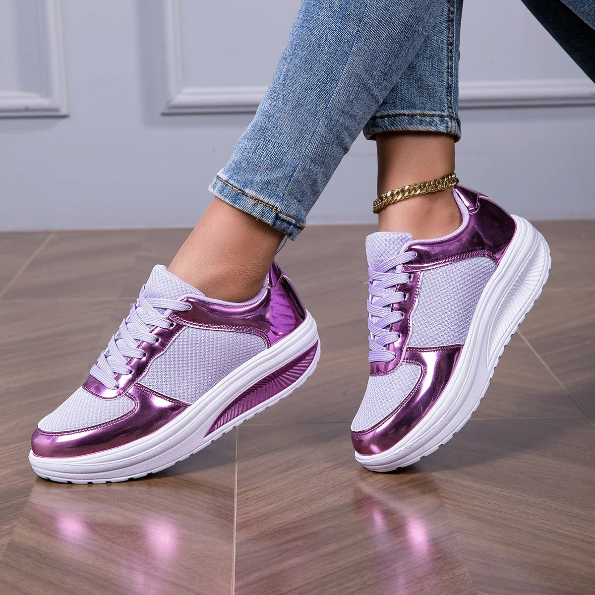 Women's walking shoes in white and metallic purple, styled with jeans on wooden floor for casual wear and light exercise
