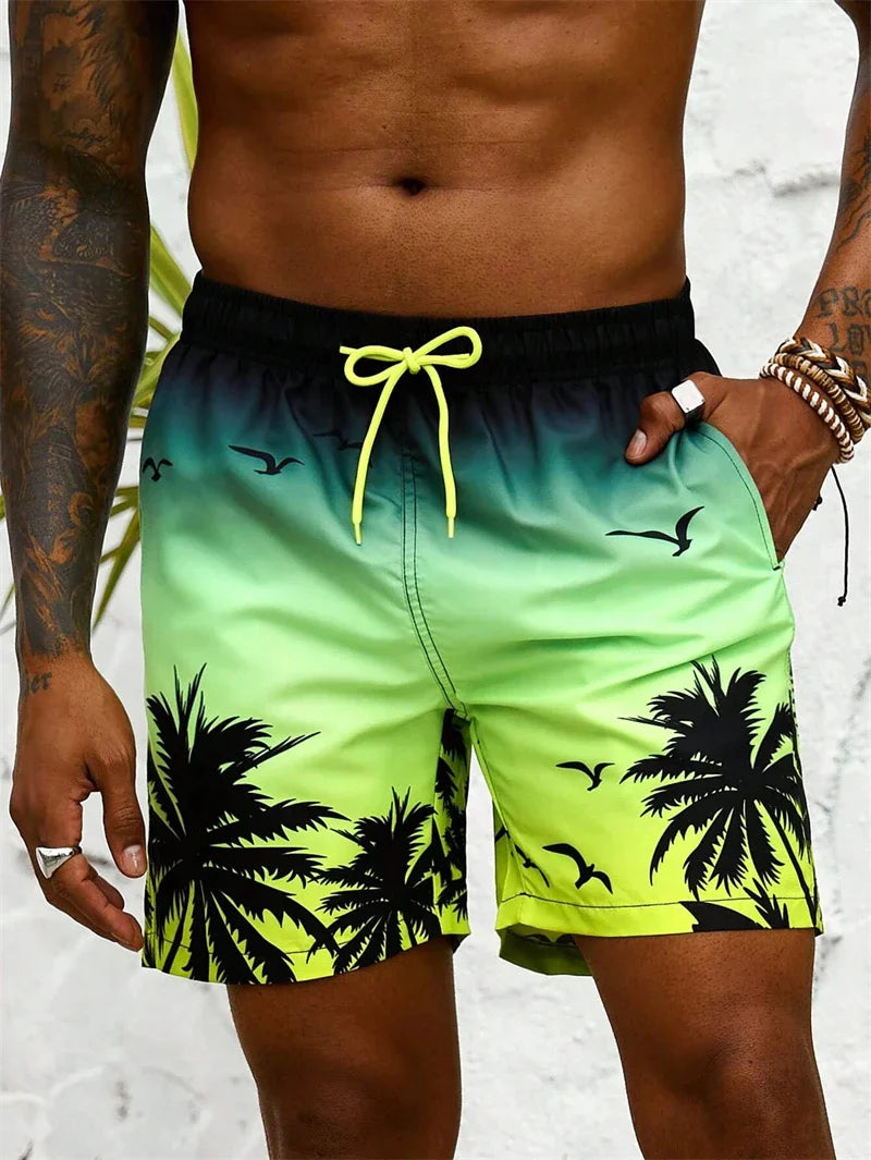 Men's summer swim trunks with palm tree and bird design in gradient green and black colors