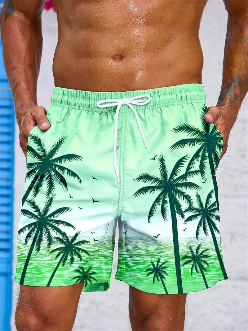 Men's summer swim trunks with green palm tree print and white drawstring for beach and pool activities