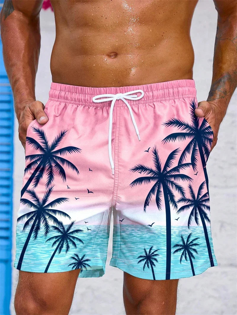 Men's summer swim trunks with pink and blue tropical palm tree design and white drawstring waistband