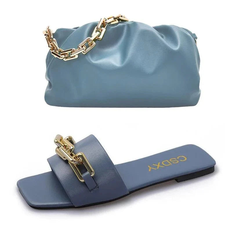 blue women's flat shoes with gold chain detail and matching blue handbag with gold chain strap set